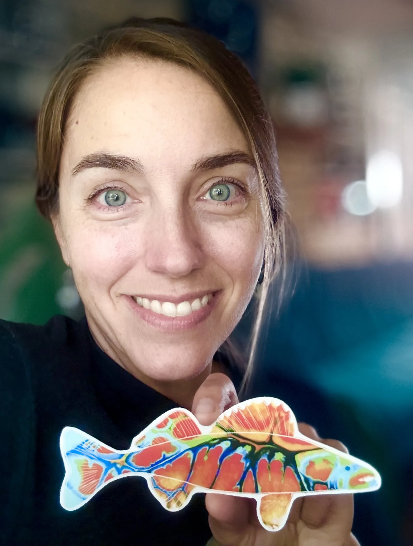 Jacqueline Biang holding a colorful fish sticker